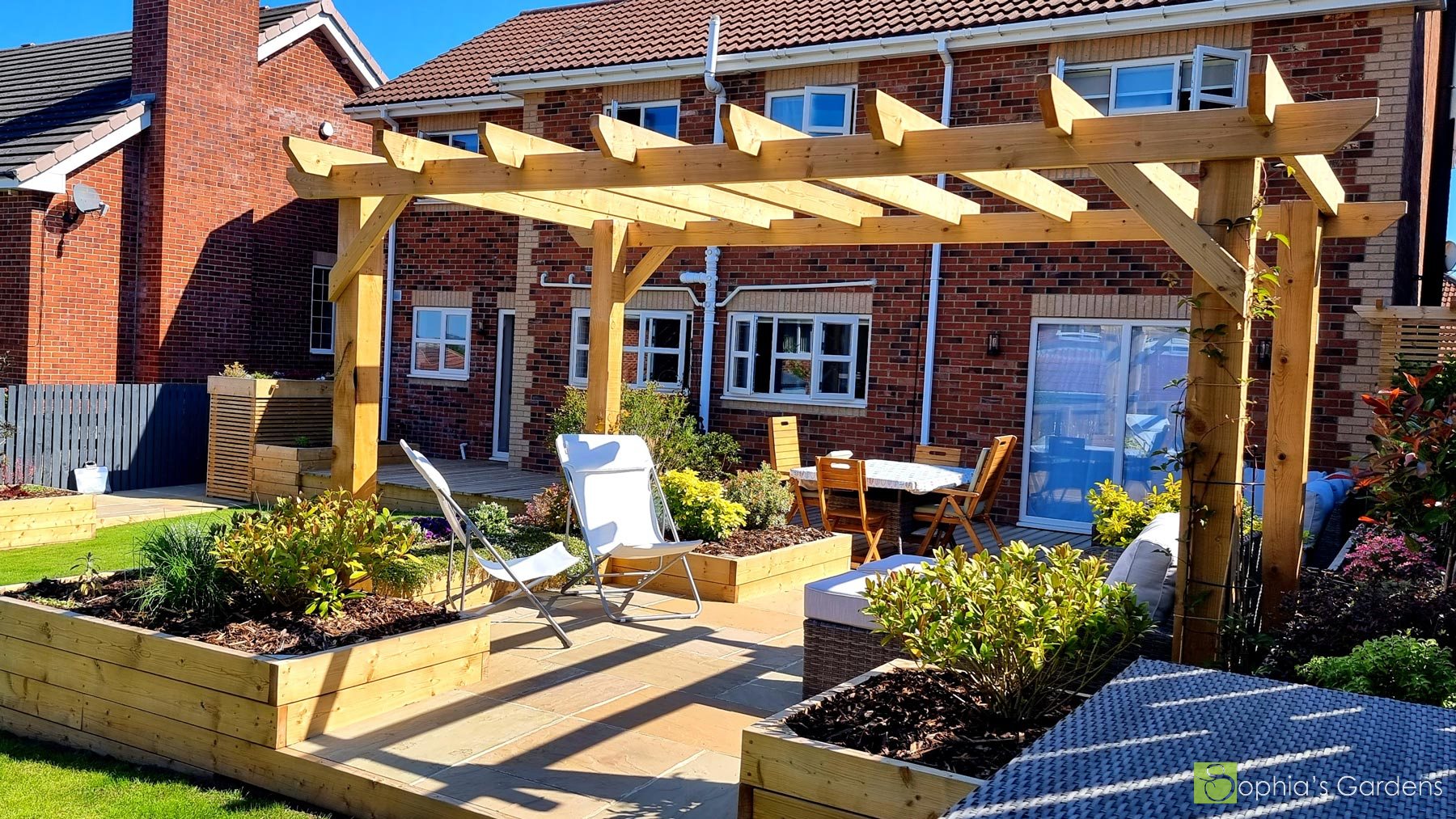 Statuesque pergola over a Siberian Larch Deck and stone patio with raised beds, in Spennymoor, by Sophia's Gardens